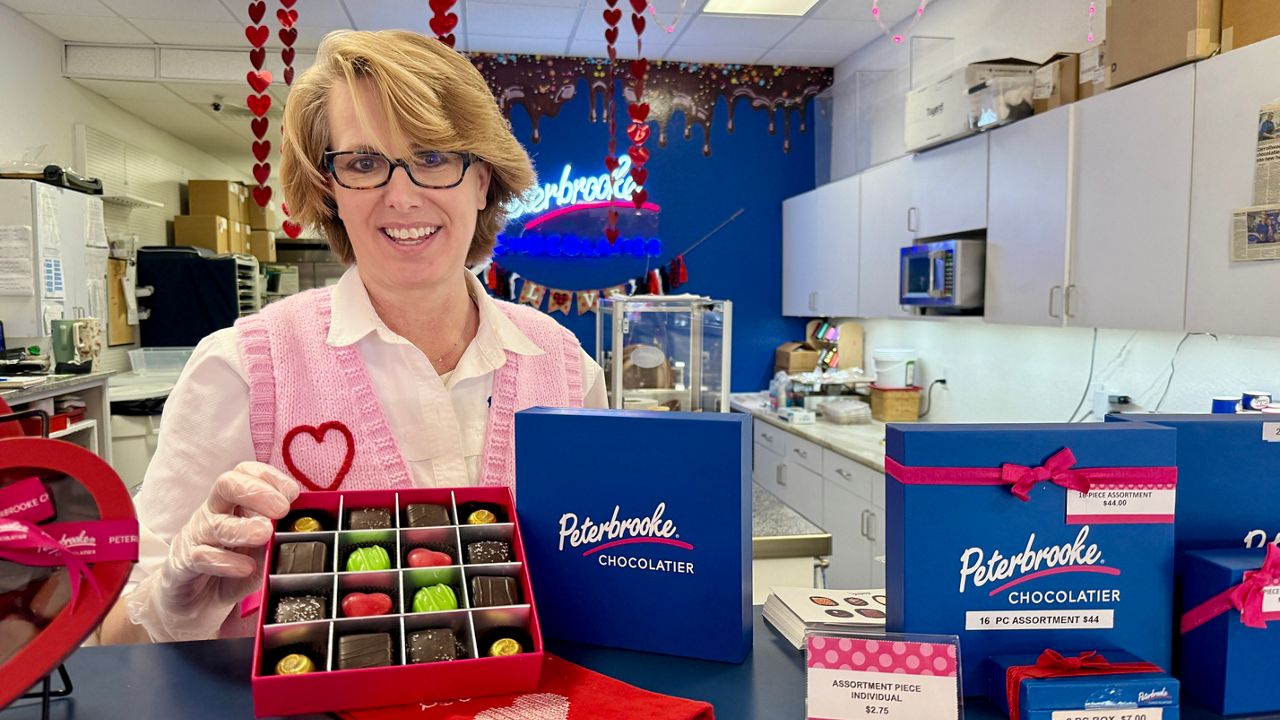 Jennifer Hill smiles with a selection of chocolates in her Carrollwood location. Photo Credit: Erin Murray