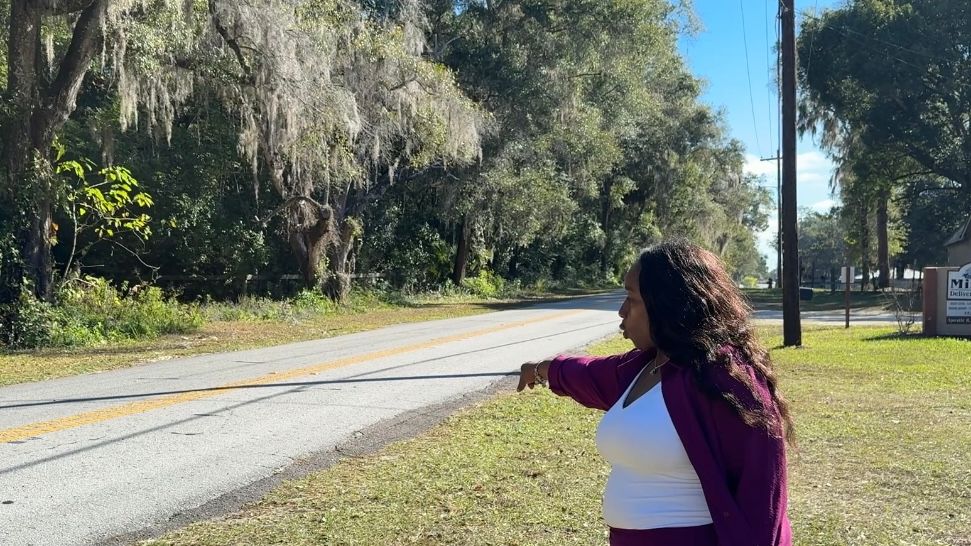 Shanta Norton, points to where her sister, Shannon Rushing, was hit and killed on Blichton Road in Ocala. (Spectrum News)