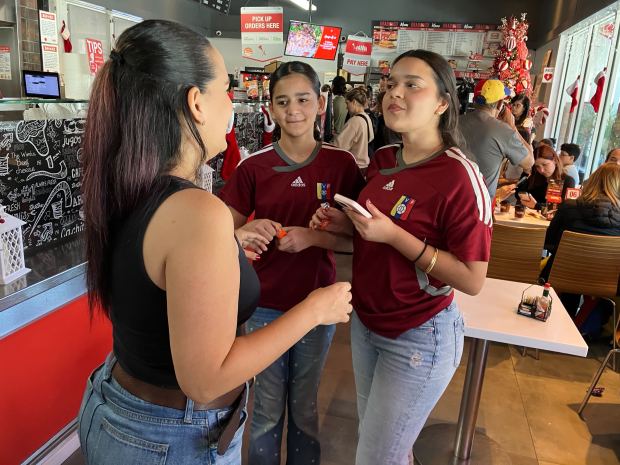 Mayra Bermudez, Fiorella Ramirez and Fabiana Ramirez gather wearing shirts at Panna on Saturday, following the capture of Maduro.