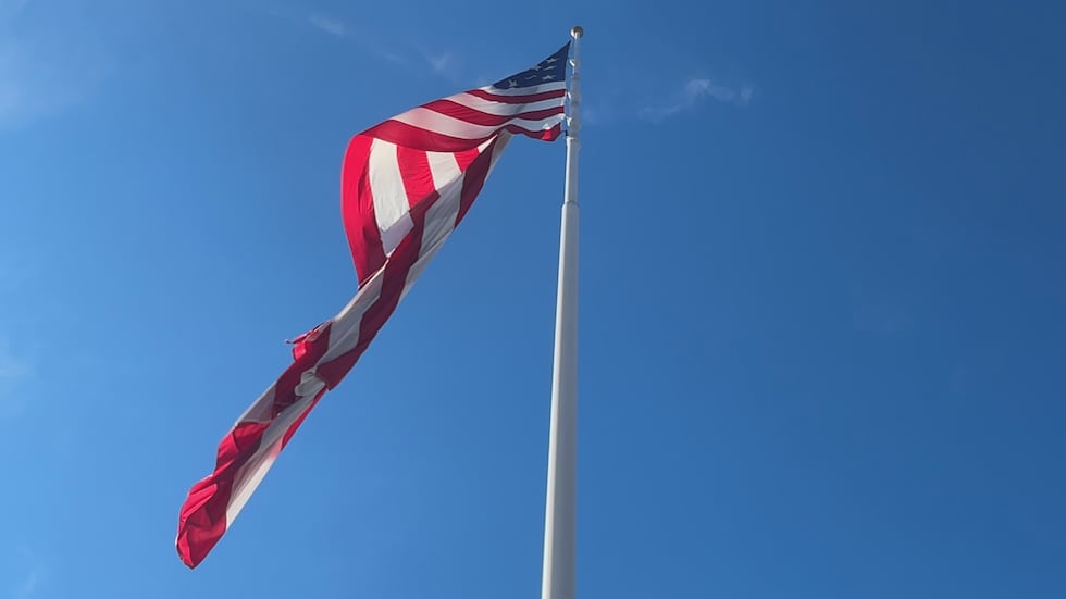 An American flag waves in the wind on Tuesday outside a Camping World location. 