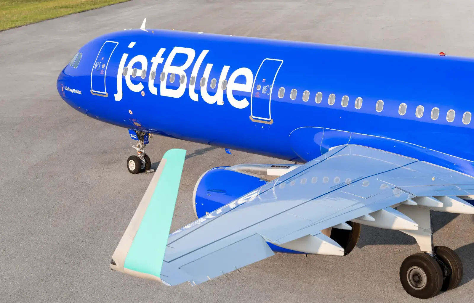 JetBlue Airbus A321 aircraft in blue Mint livery parked on runway