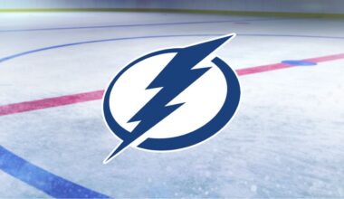 Tampa Bay Lightning primary logo on a background showing the center ice of a hockey rink.
