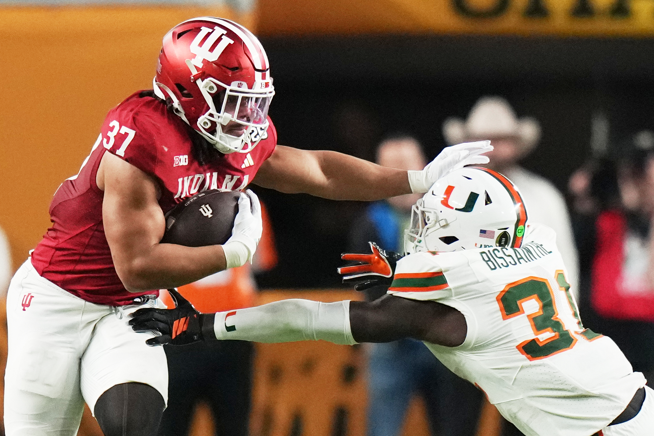Indiana tight end Riley Nowakowski pushes off Miami linebacker Wesley Bissainthe during the first half of the College Football Playoff national championship game, Monday, Jan. 19, 2026, in Miami Gardens, Fla. (AP Photo/Lynne Sladky)