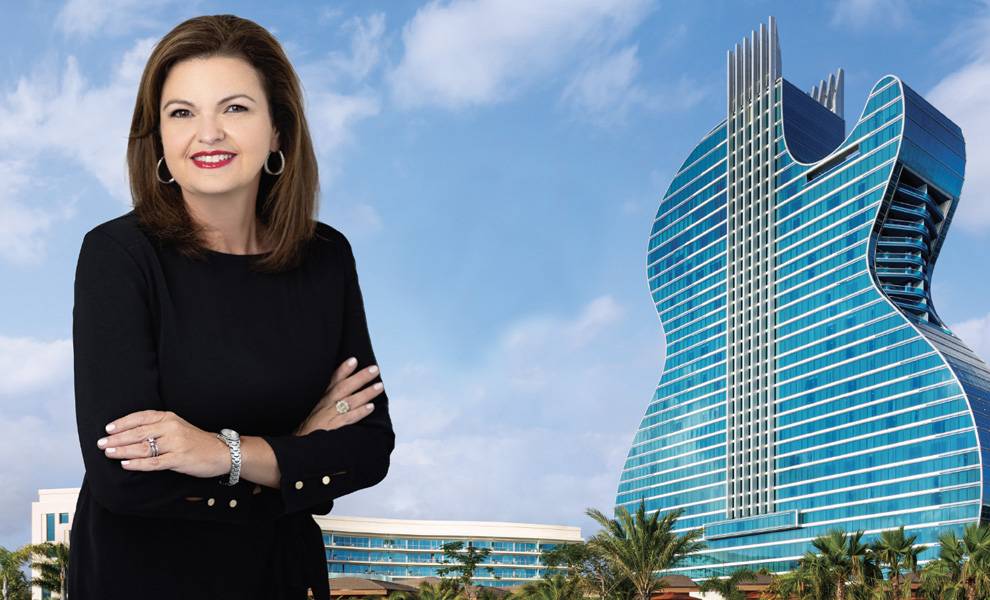 Lourdes Mola sets vision for Latin market growth at Seminole Hard Rock Hotel & Casino Hollywood, FL 2 Lourdes Mola from Seminole Hard Rock Hotel and Casino Hollywood smiling in a black dress in front of The Guitar Hotel.