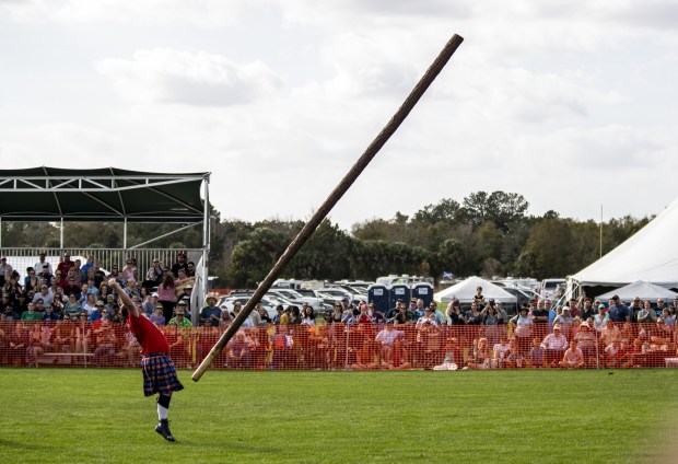 An athlete participates in the caber toss during the 43rd annual Central Florida Scottish Highland Games at Central Winds Park in Winter Springs. (Patrick Connolly/Orlando Sentinel)