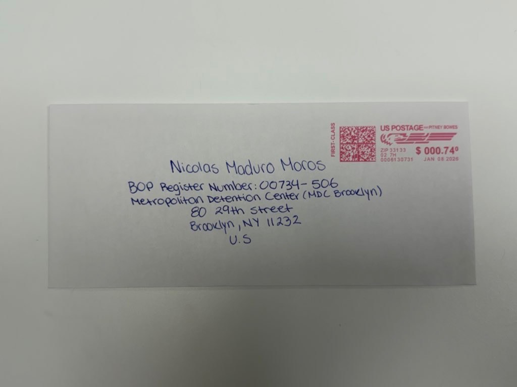 A white envelope with the words "Nicolas Maduro Moros" and other blue ink.