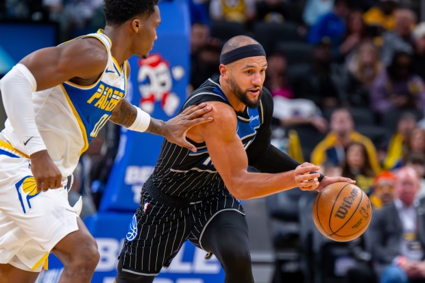Orlando Magic guard Jalen Suggs, right, runs up court with the ball while being defended by Indiana Pacers guard Bennedict Mathurin during the second half of an NBA basketball game in Indianapolis, Wednesday, Dec. 31, 2025. (AP Photo/Doug McSchooler)