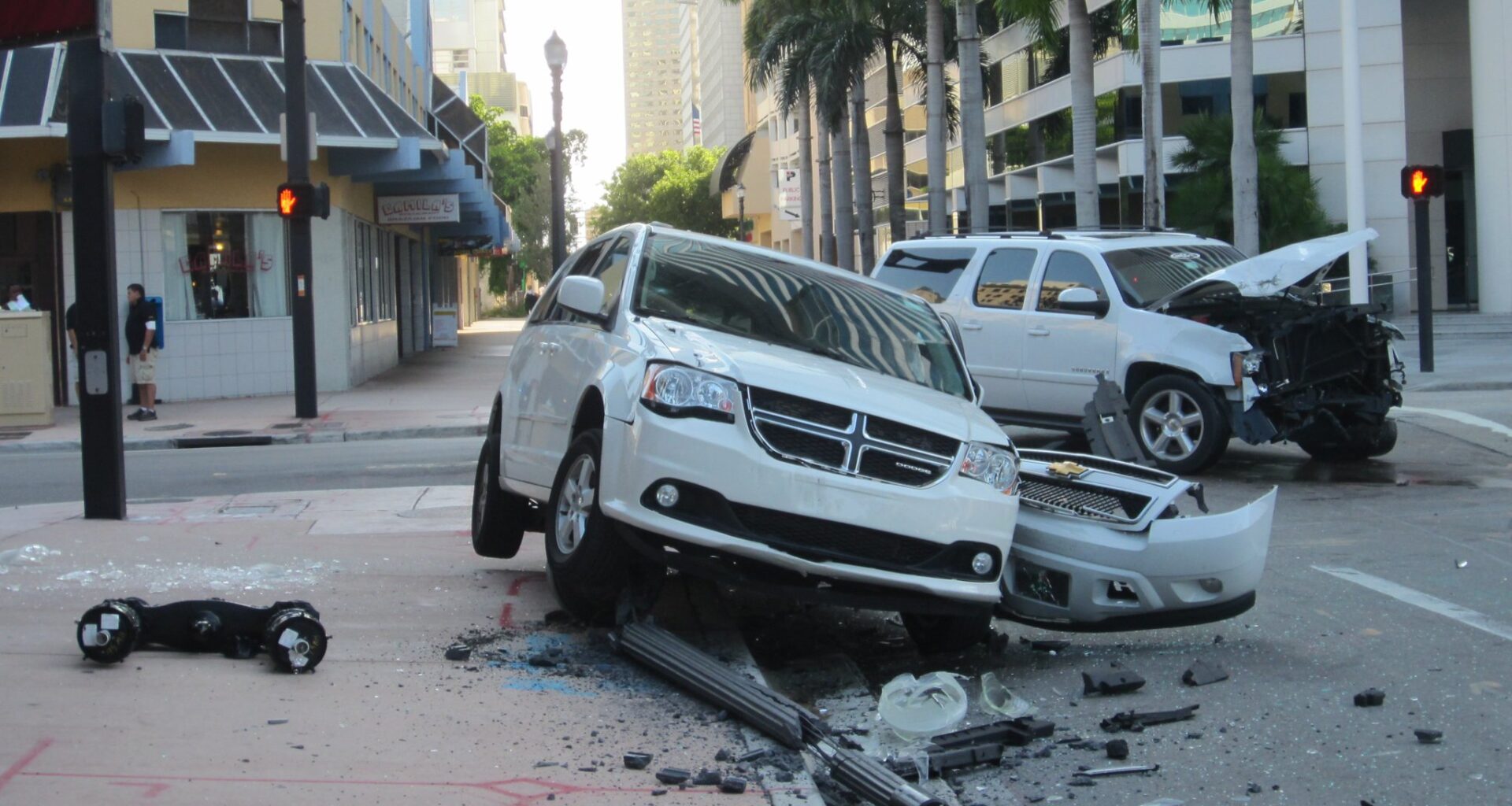 a damaged white van and white SUV in the aftermath of a crash