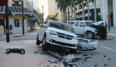 a damaged white van and white SUV in the aftermath of a crash