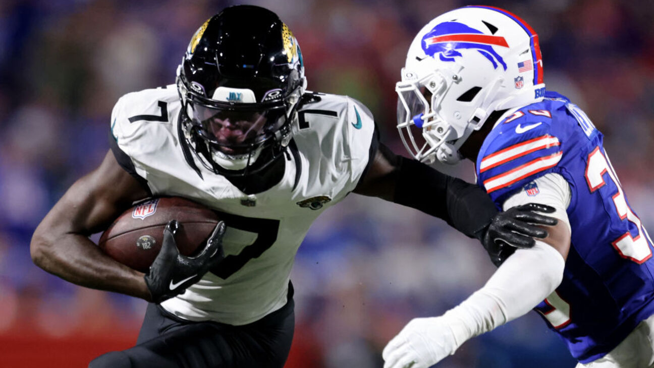 Brian Thomas Jr. #7 of the Jacksonville Jaguars is tackled by Cam Lewis #39 of the Buffalo Bills: How to watch Buffalo Bills vs. Jacksonville Jaguars online, livestream AFC Wild Card