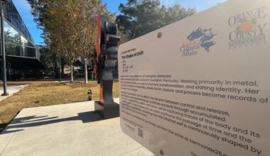 Close-up shot of Orange County Arts & Cultural Affairs sign and recent sculpture addition 'The Shape of Drift' by Ariana Berman. (Spectrum News)