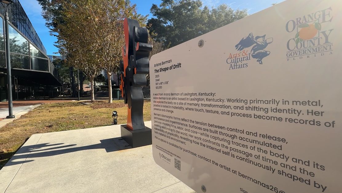 Close-up shot of Orange County Arts & Cultural Affairs sign and recent sculpture addition 'The Shape of Drift' by Ariana Berman. (Spectrum News)