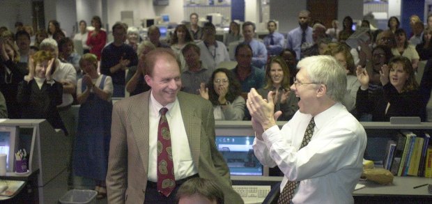 Orlando Sentinel editor L. John Haile, right, applauds editorial writer John Bersia, left, who won the Pulitzer Prize for editorial writing, Monday, April 10, 2000 in Orlando, Fla. Bersia won the prize for his series of editorials against predatory lending practices in Florida, called "Fleeced in Florida." (AP Photo/Orlando Sentinel, Joe Burbank) ORG XMIT: FLORL101