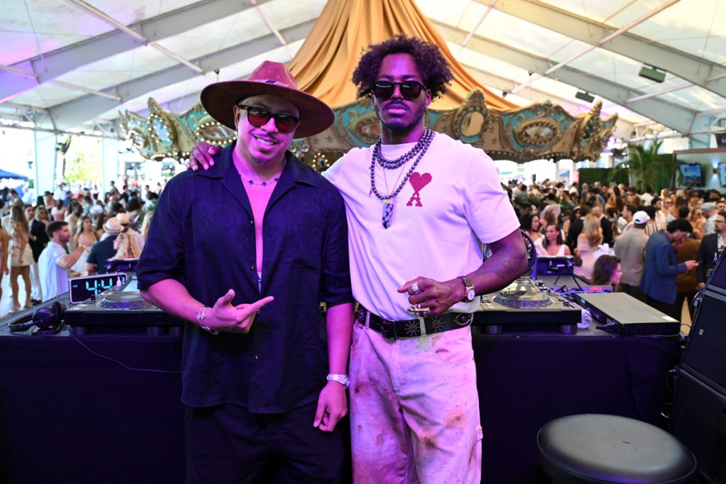 Photo of two men on a stage posing for the camera . 