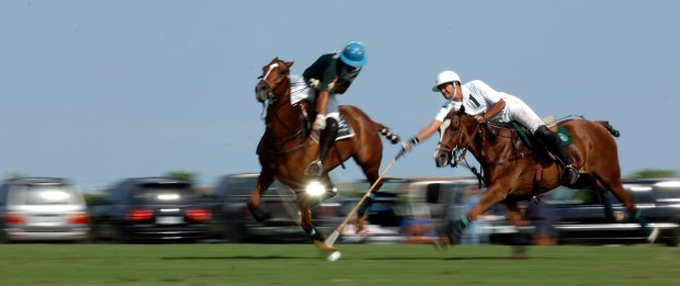(mr) POLO04A, WELLINGTON, 4/4/2007 -- Bendabout's' Ignacio Toccalino (left) and White Birch's Ulysses Escapite battle for the ball during Wednesday's polo match at the International Polo Club in Wellington. Staff Photo By Mark Randall