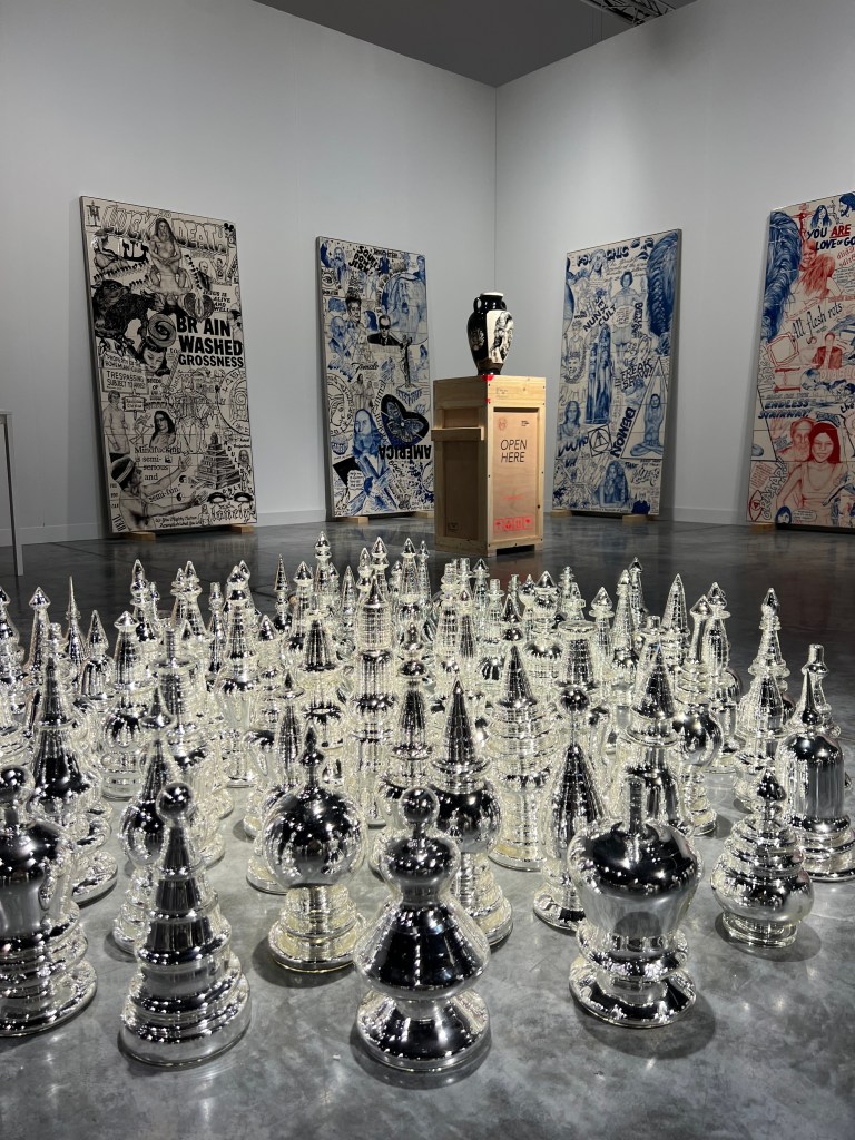 Renata Petersen's exhibition at Art Basel Miami, featuring three distinct and apparently disconnected works: murals made from tiles, covered with slogans and representations of generational icons; ceramic vases with refined decorations; and blown glass. 