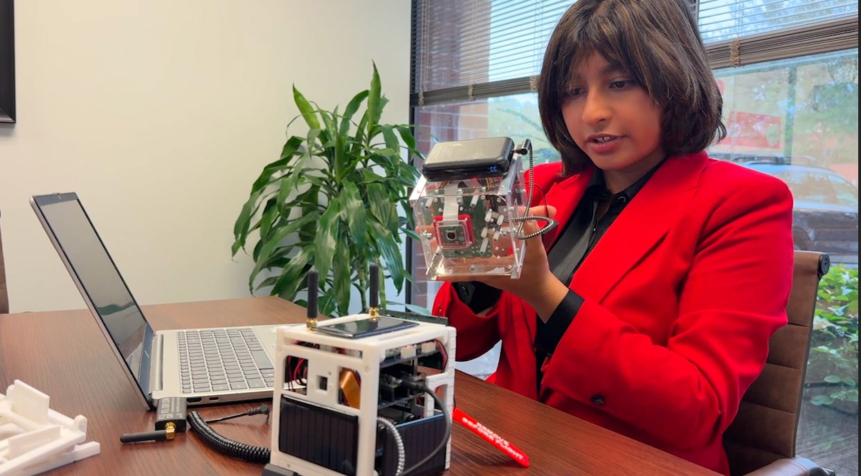 Abigail Merchant goes over a cubesat she designed to help first responders detect flooding, assess damage, and locate survivors faster than ever before. (Spectrum News)