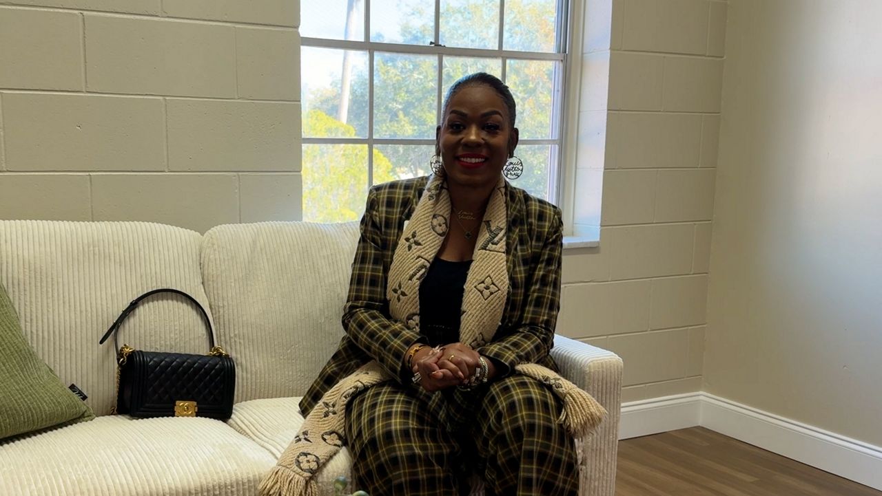 Cherlette McCullough sits in one of the new rooms at the Outlook Clinic in Sanford on the opening day. (Spectrum News)