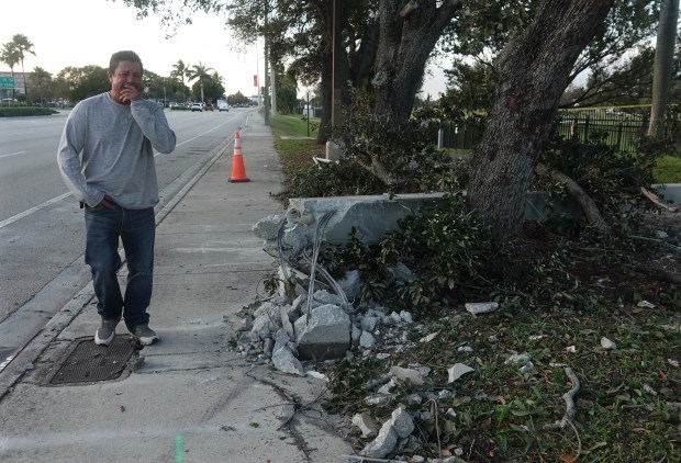 Juan Alcocer, father of one of the three teens killed Monday night in a Pompano Beach car crash, visits the site of the crash, Tuesday, Dec. 30, 2025. (Joe Cavaretta/South Florida Sun Sentinel)