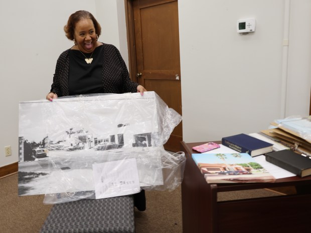 Curator Imani Warren holds a photo print from the 1960s that will be featured in the Sistrunk Then and Now exhibit at the Historic Old Dillard Museum in Fort Lauderdale, Tuesday, Jan. 6, 2026. (Joe Cavaretta/South Florida Sun Sentinel)