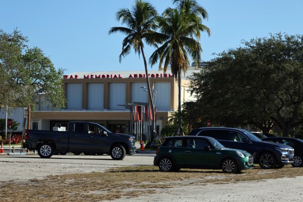A dirt parking lot sits across from War Memorial Auditorium and southeast of The Parker at Holiday Park in Fort Lauderdale on Wednesday. Fort Lauderdale plans to build a modern parking garage to serve patrons of the park. (Joe Cavaretta/South Florida Sun Sentinel)