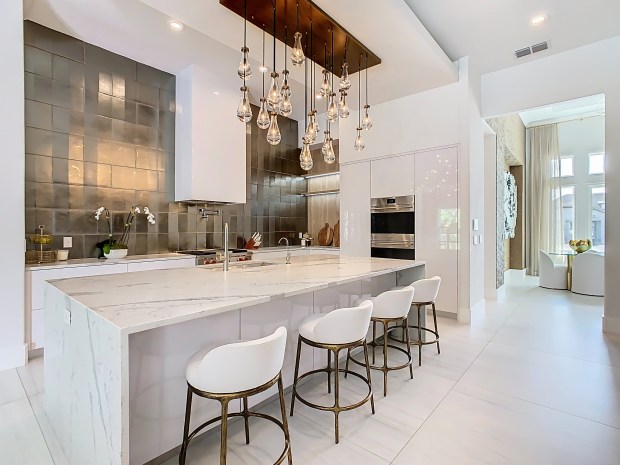 Part of the renovation involved relocating the kitchen and adding top-of-the-line appliances, like Wolf and SubZero. (Photo by Tyto Media)