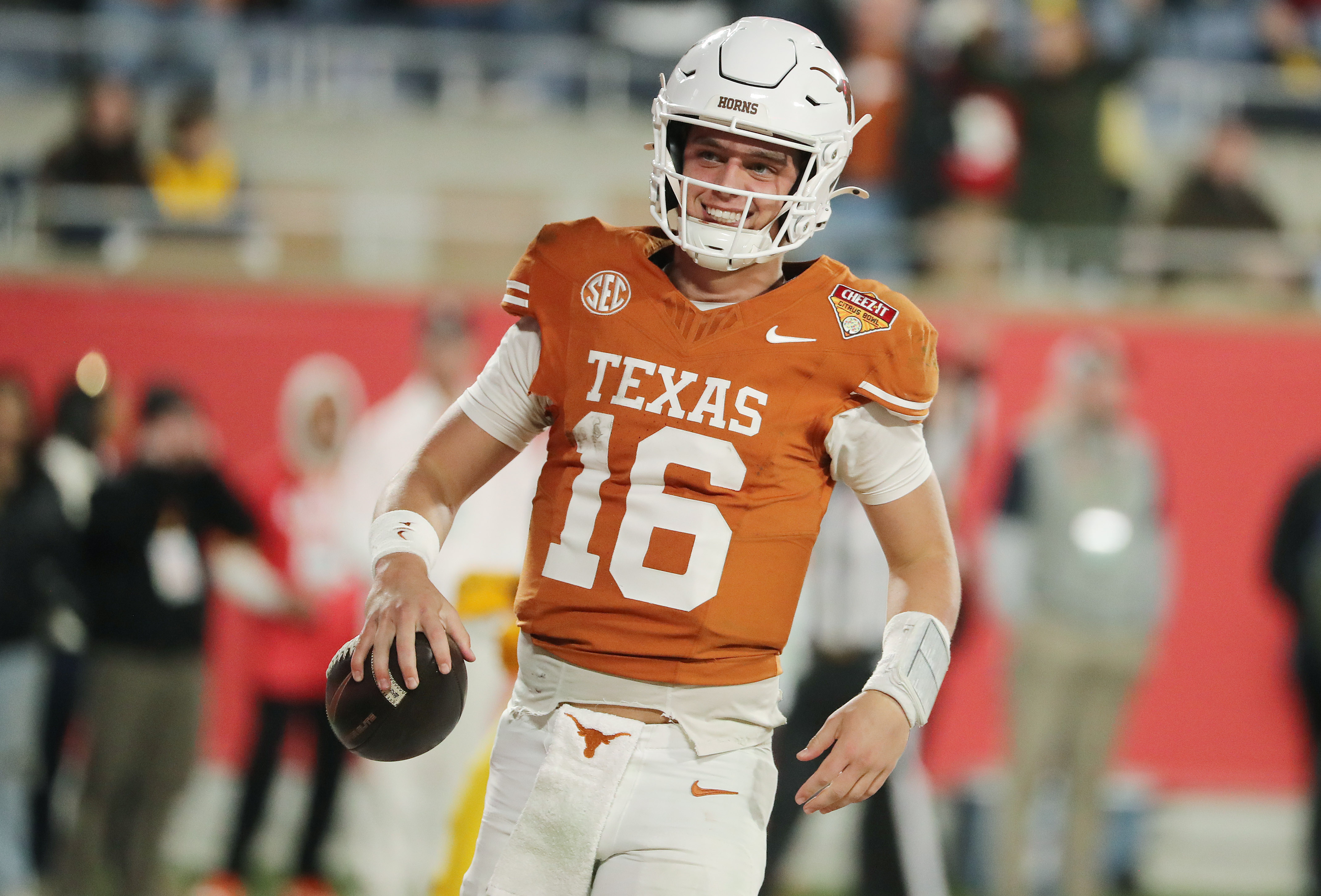 Texas quarterback Arch Manning celebrates as he scores a rushing...