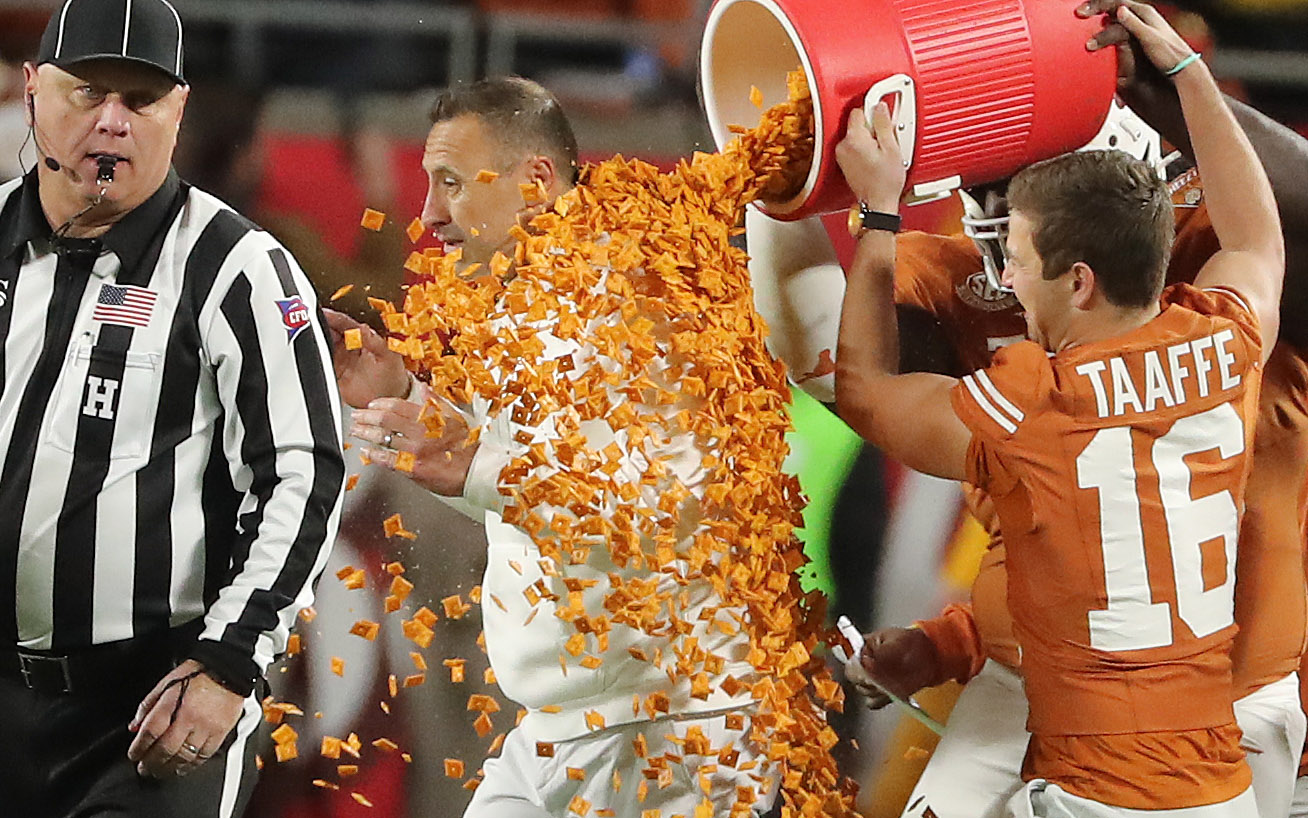 Texas head coach Steve Sarkisian is dunked in Cheez-Its after...