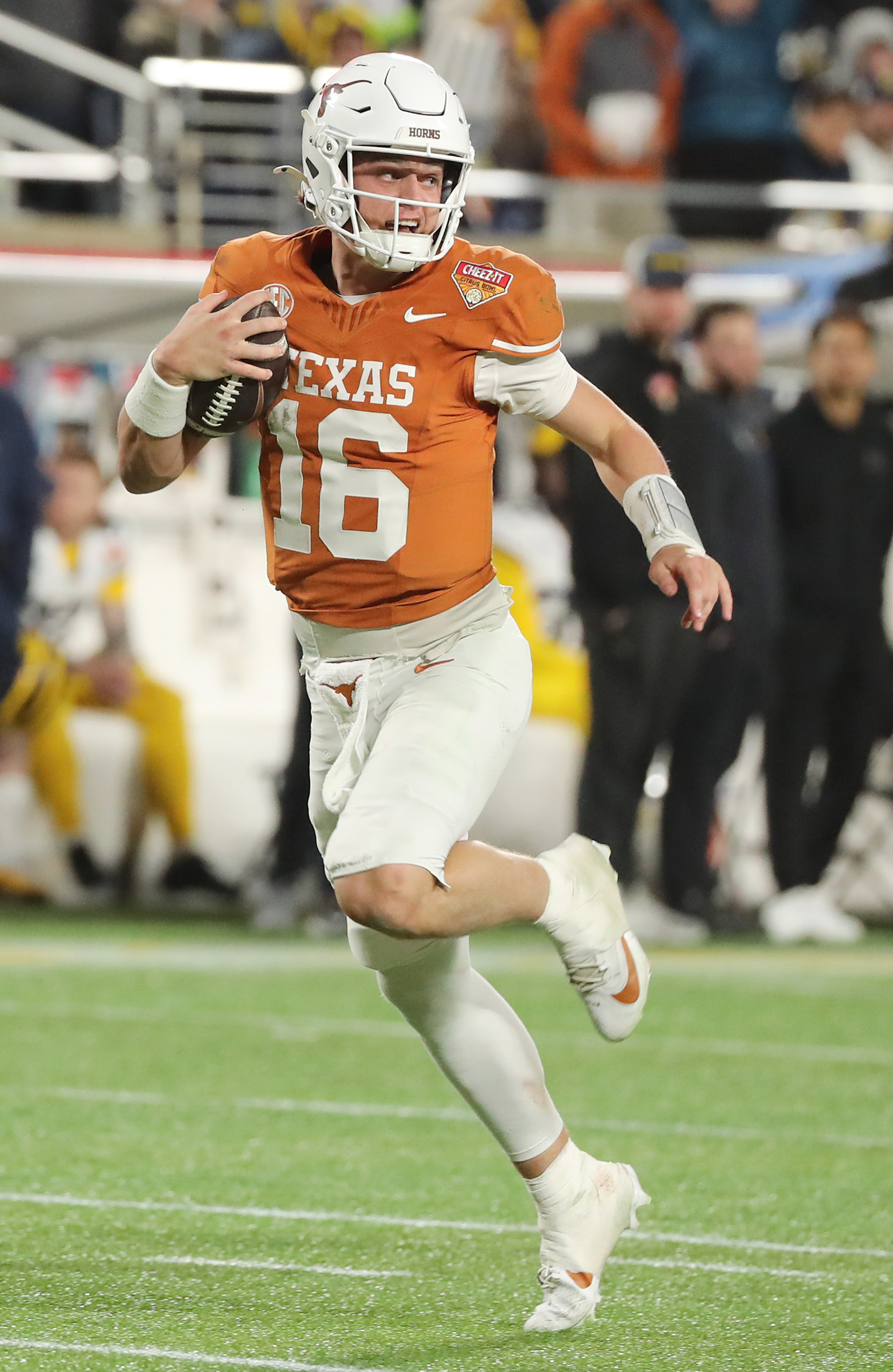 Texas quarterbackk Arch Manning (16) runs into the endzone for...