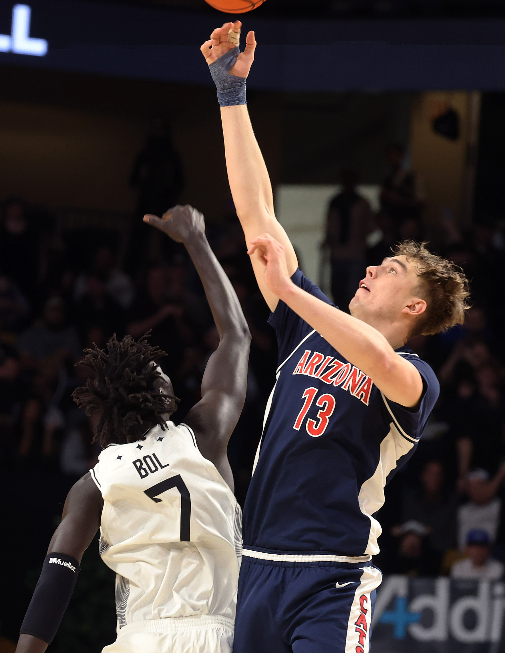 UCF center john Bol (7) and Arizona center Mo Kharchenkov...
