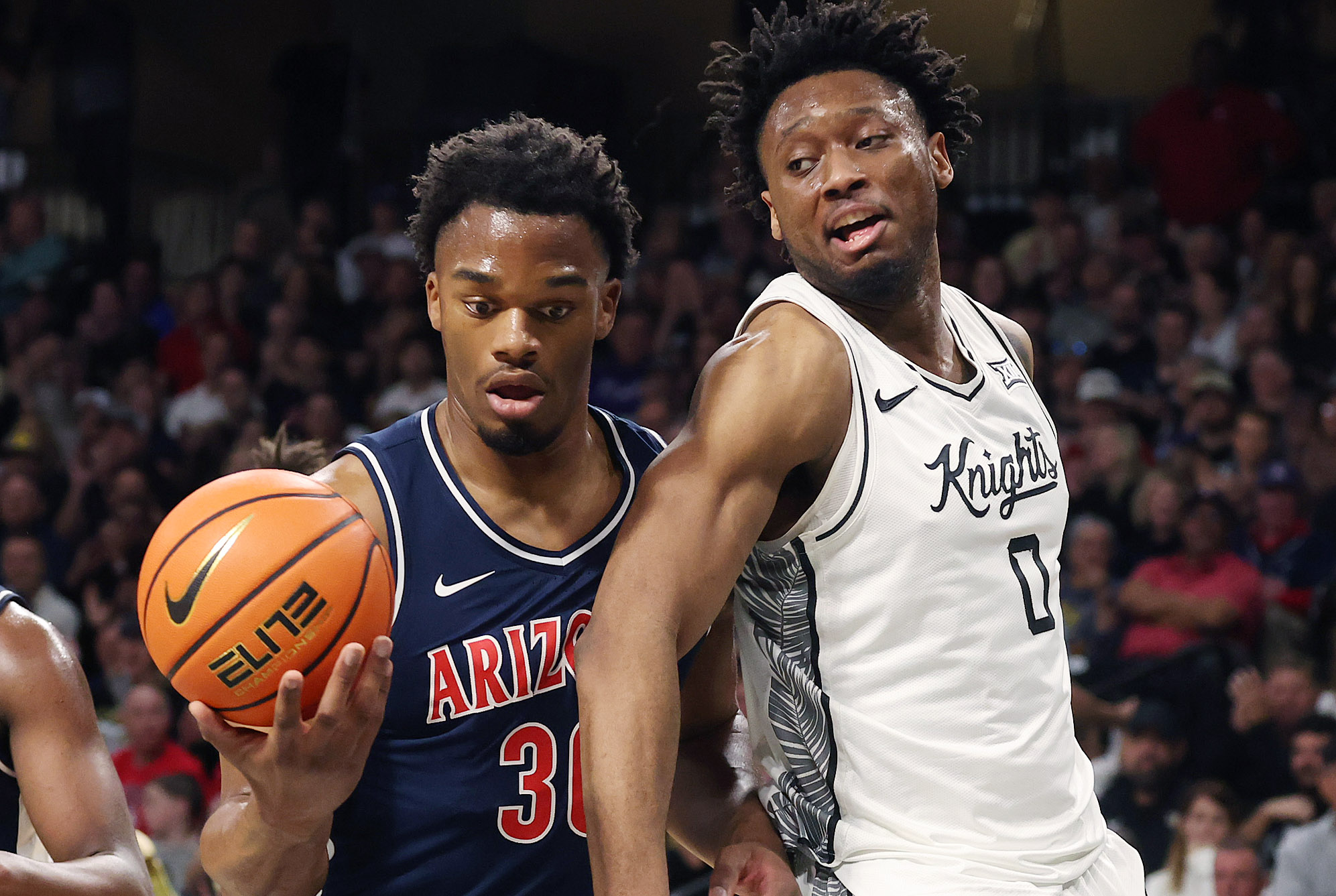Arizona forward Tobe Awaka (30) takes the ball from UCF...