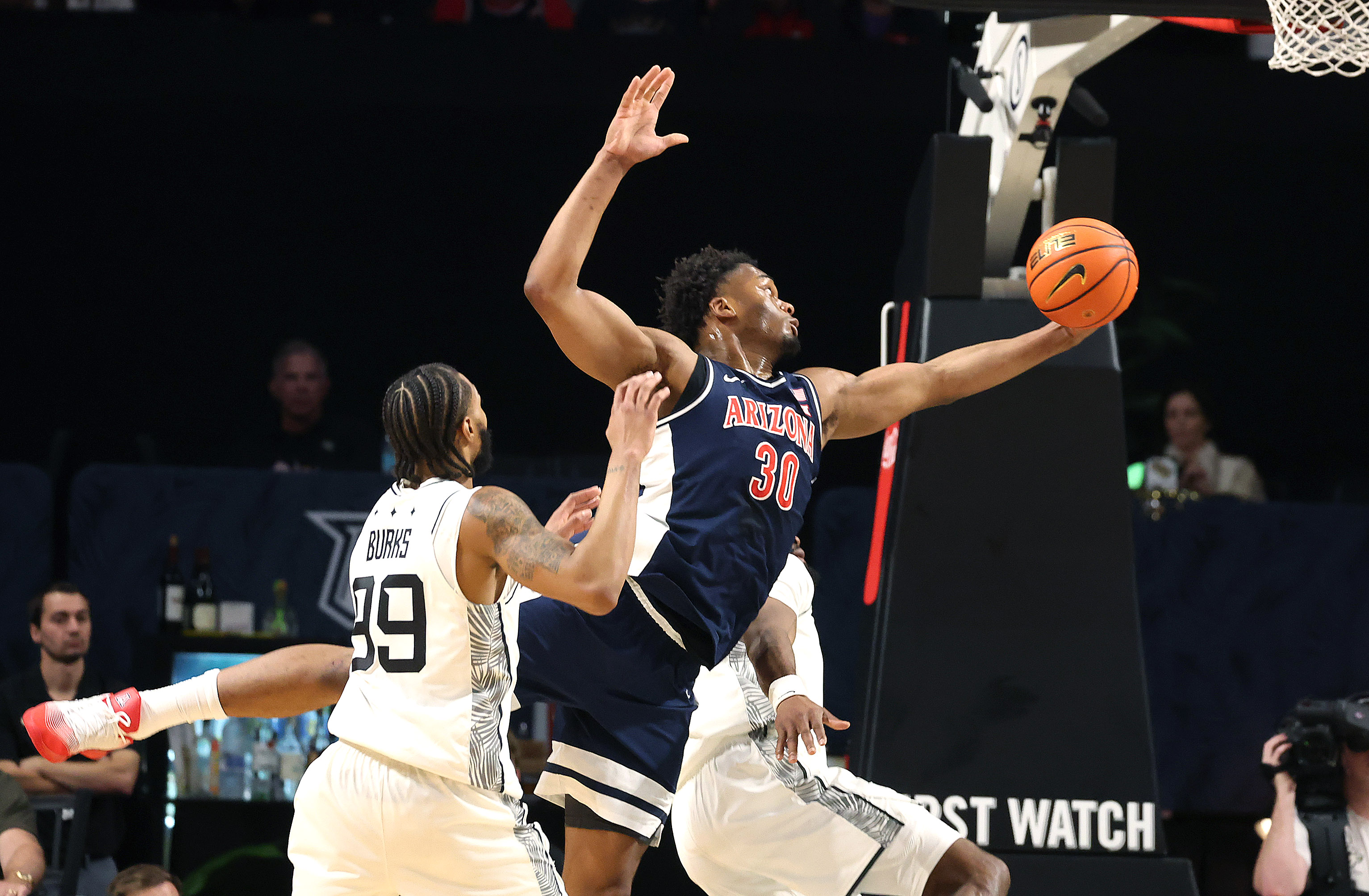 Arizona forward Tobe Awaka (30) grabs a rebound over UCF...