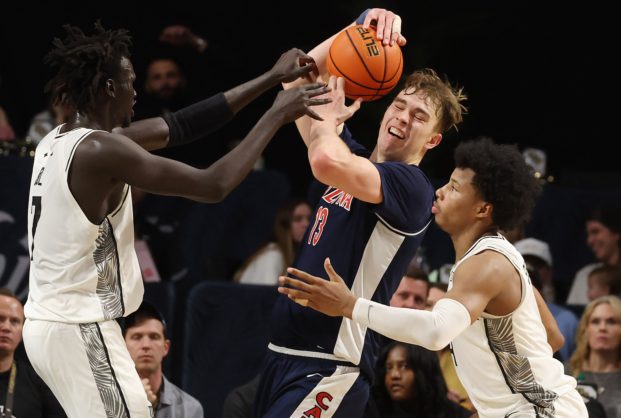 Arizona center Mo Krivas (13) fights for a rebound with...
