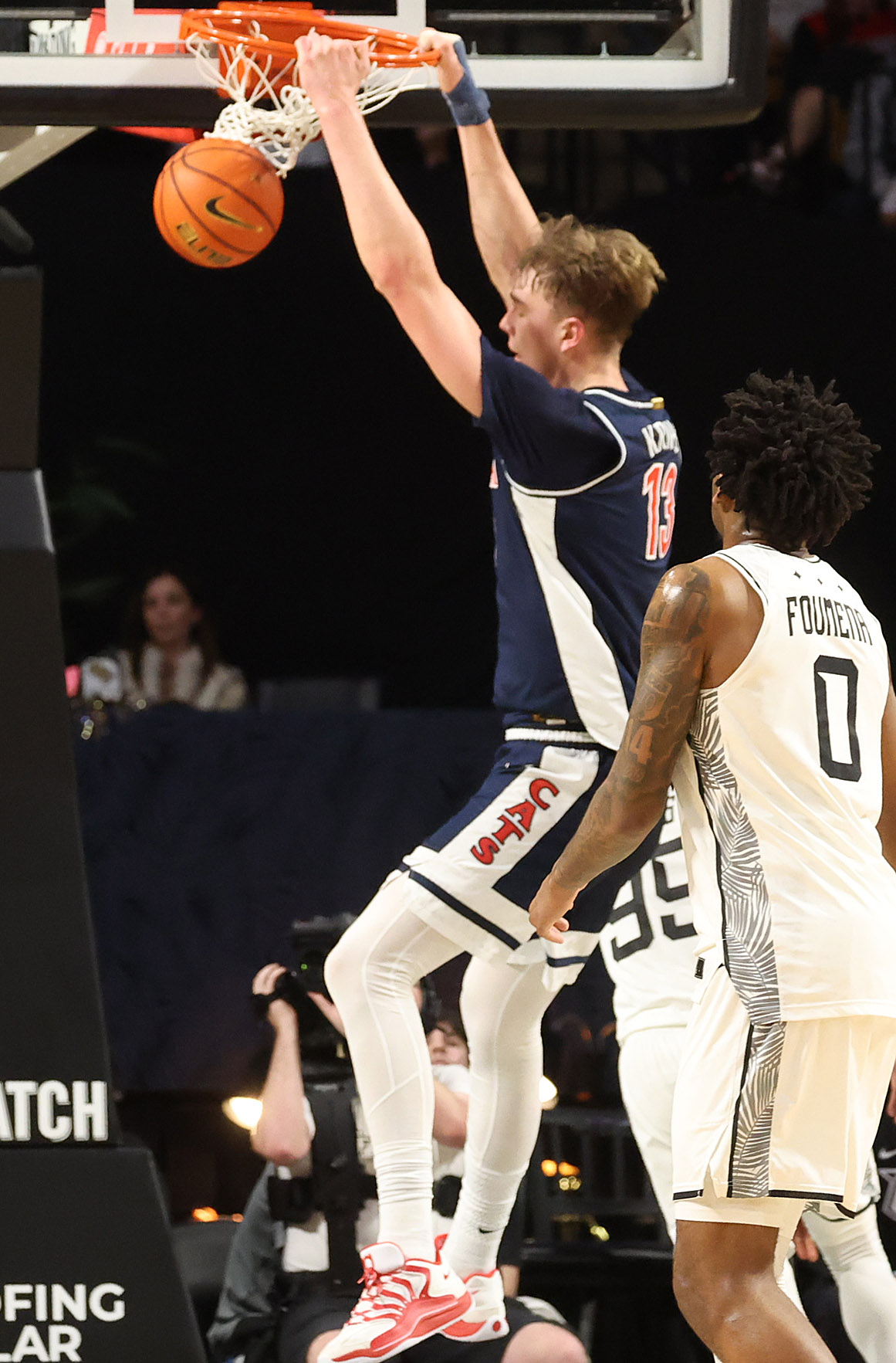 Arizona center Mo Krivas (13) slam dunks during the Arizona...