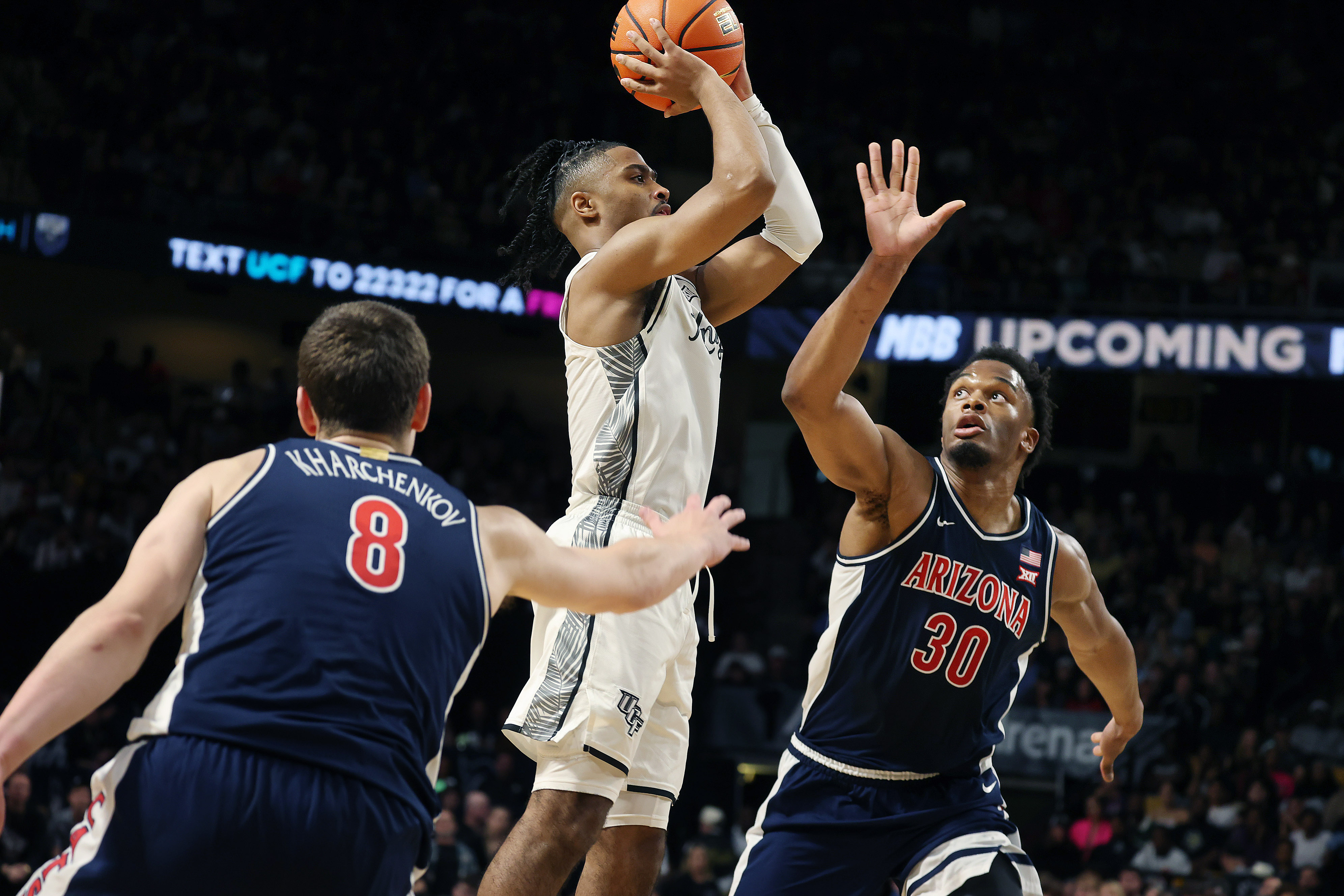 UCF guard Themus Fulks (1) shoots between Arizona forwards Ivan...