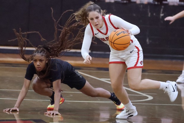Colonial's Yaneyla Pedraza (right) and Ocoee's Dakara Merthie (left) scrambled for a loose ball in a Tuesday girls basketball game. Ocoee won by one point. (Stephen M. Dowell/Orlando Sentinel)