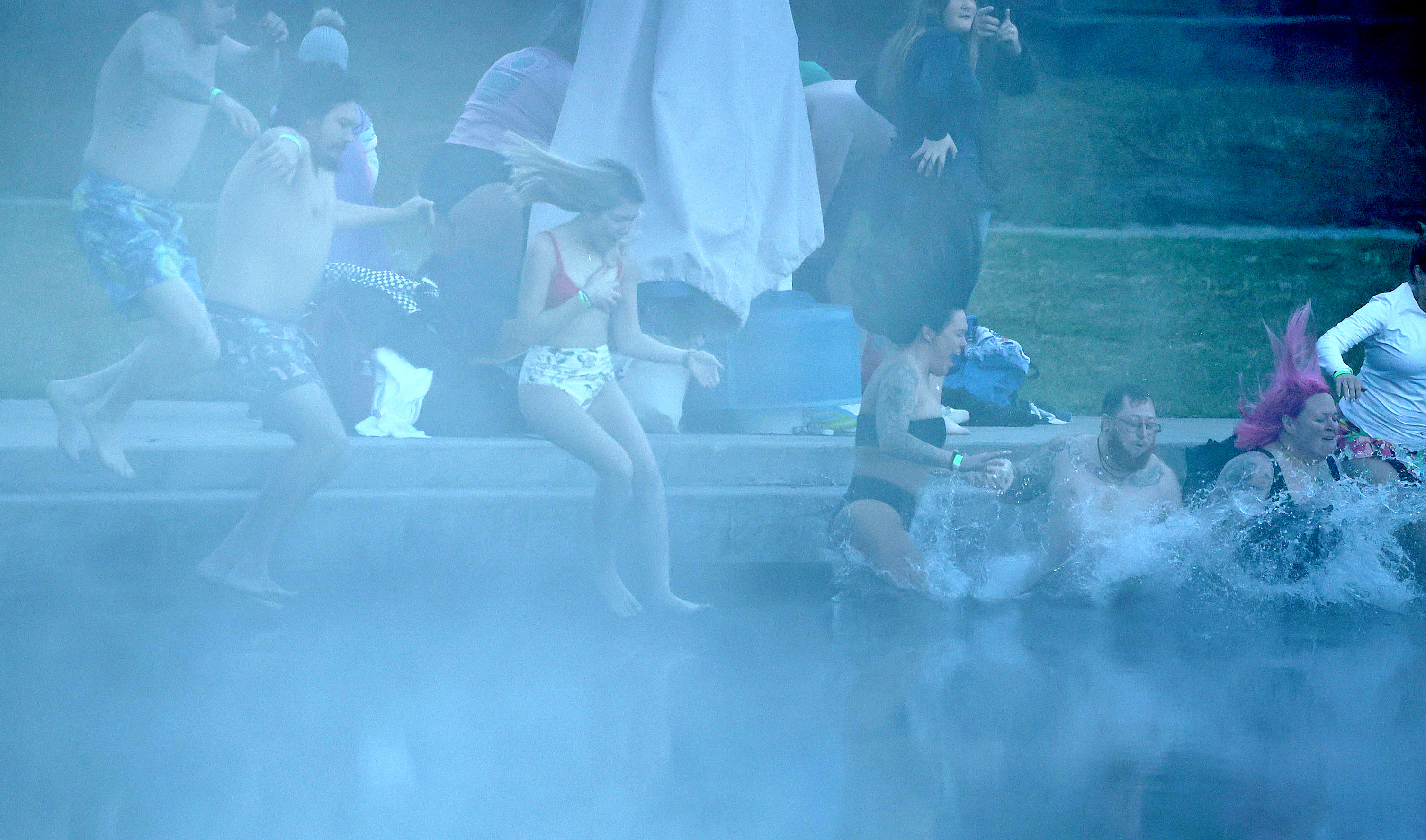 Participants in the early-morning mist brave the 32-degree weather to...