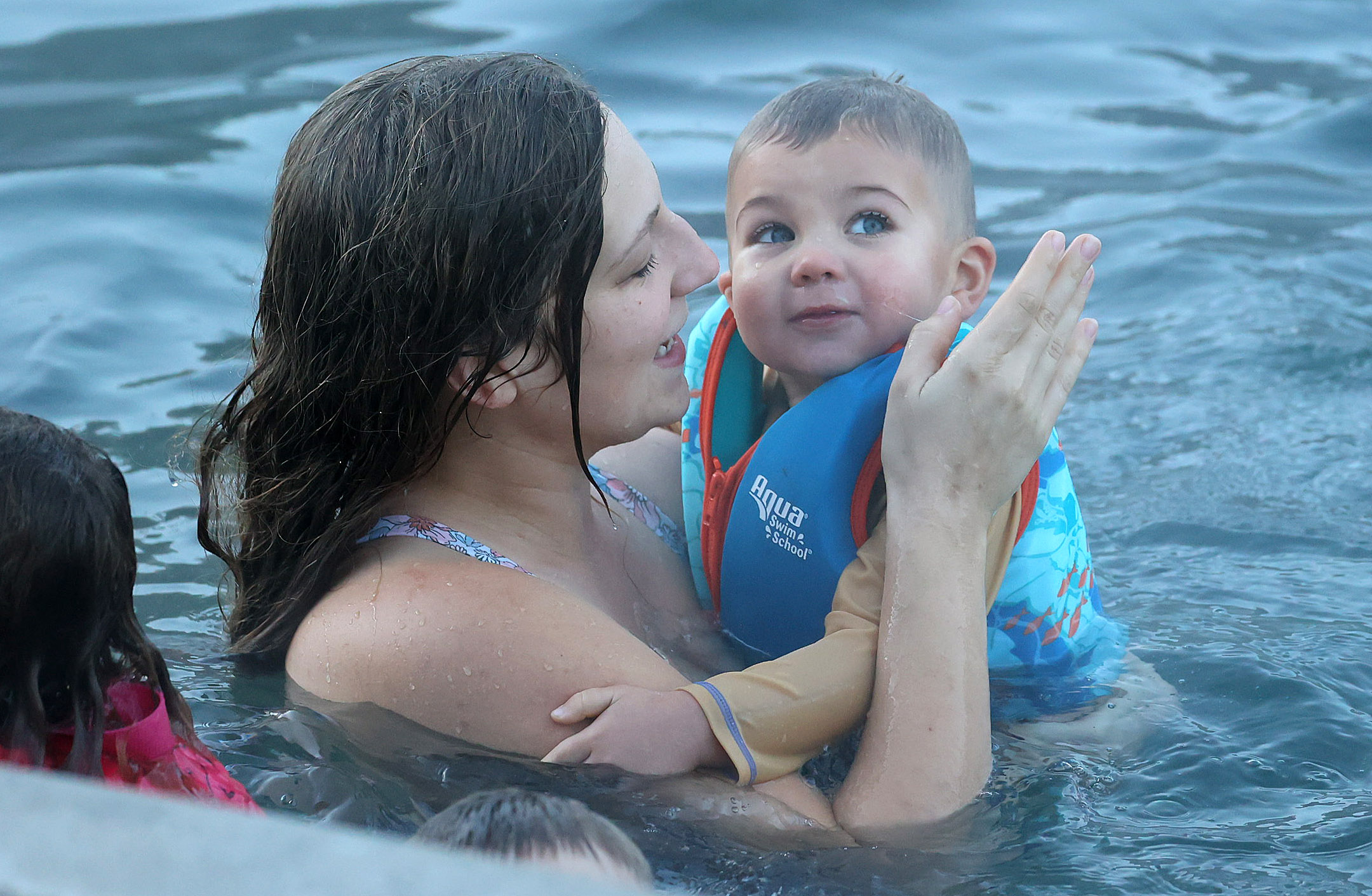 A baby doesn't seem to mind braving the 32-degree weather...
