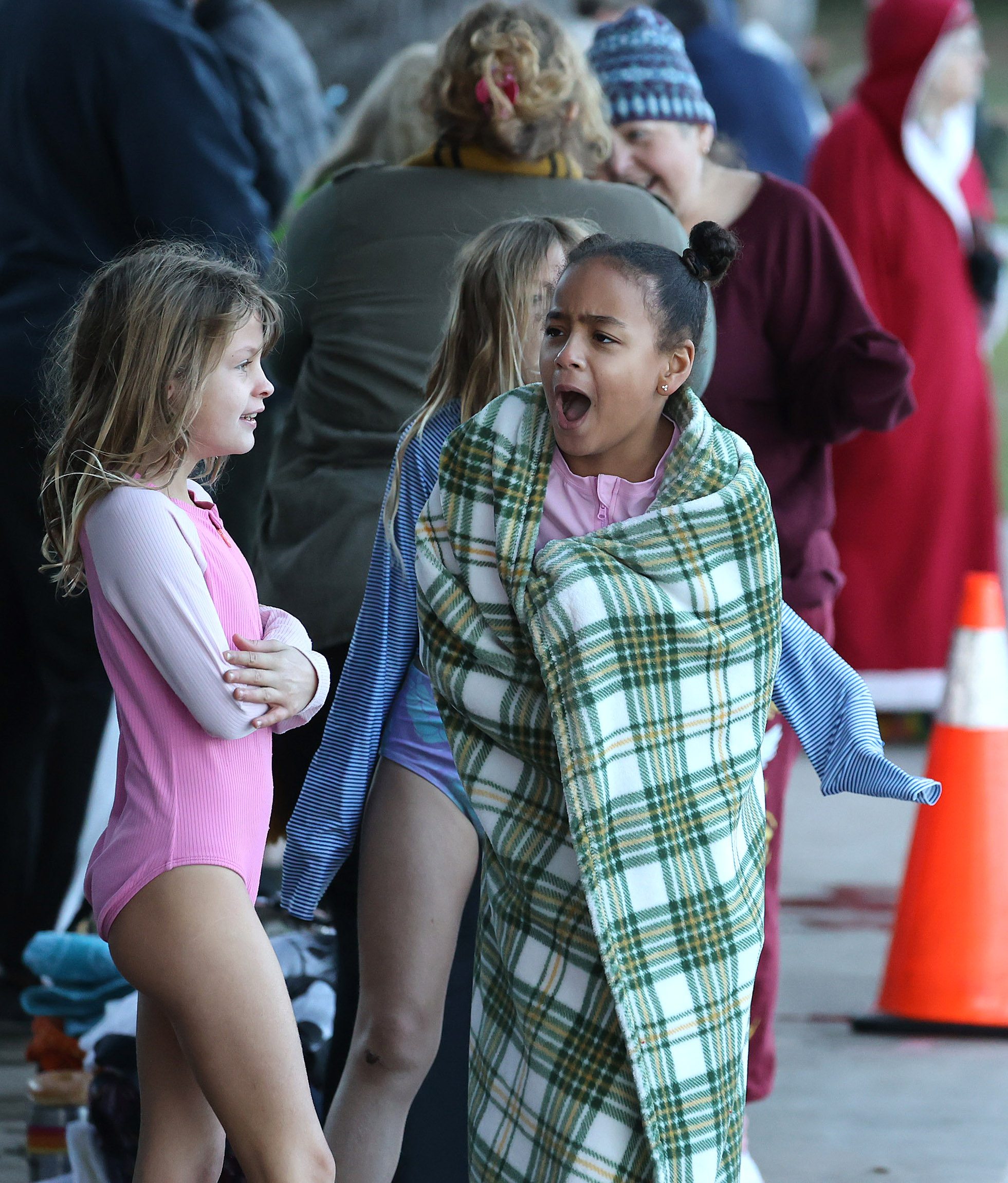 Kids shiver in the 32-degree weather before leaping into the...