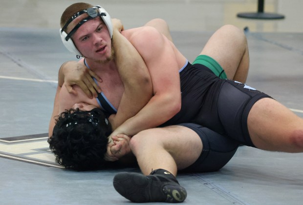 Hagerty High's Jude DiCicco (top) controls Fort Myers wrestler Daniel Reyes during a wrestling meet at Hagerty High School in Oviedo on Friday, December 12, 2025.(Stephen M. Dowell/Orlando Sentinel)