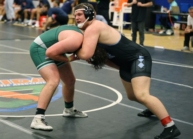 Hagerty High's Renzo Cooligan (right) grapples Flagler Palm Coast High's Aiden Korth during the FHSAA Wrestling Dual Meet Championships at Osceola High School in Kissimmee on Friday, January 23, 2026. (Stephen M. Dowell/Orlando Sentinel)