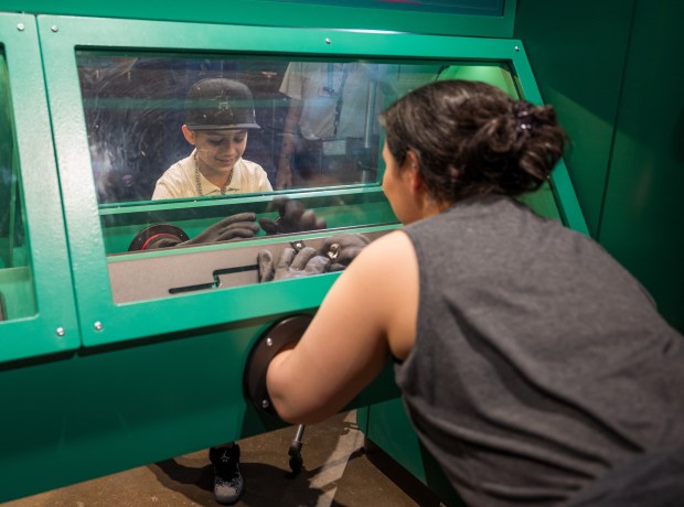 'Mission: Astronaut' includes an exploration of spacesuits and a chance to complete tasks while donning the big gloves that are used. (Orlando Science Center)