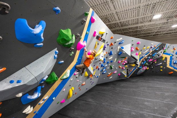 Alex Servis, a Central Rock Gym employee based in New York, showcases his bouldering skills at Central Rock Orlando, a new 25,000-square-foot facility, on Nov. 21, 2023. (Patrick Connolly/Orlando Sentinel)