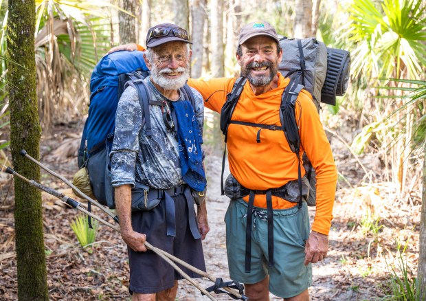 Greg Pflug meets Grits, another thru-hiker, in Little Big Econ State Forest while walking the entire Florida Trail. (Patrick Connolly/Orlando Sentinel)
