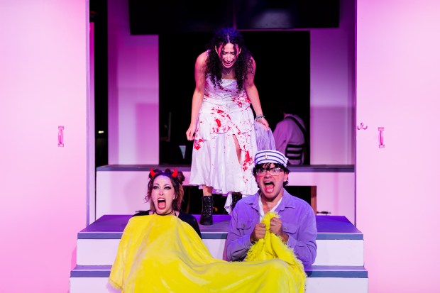 Lauren Cole and Joe Russi comically guide Cady (Isabel Bernal, center) through high school as narrators of the Renaissance Theatre Company production of "Mean Girls," at 54 W. Church St in Orlando. (Courtesy Jake Pearce via Renaissance Theatre)