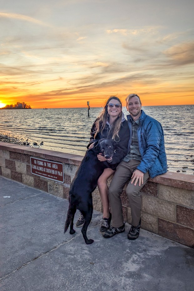 Central Florida Explorer Patrick Connolly joins his girlfriend Karissa Bellile and Leo the black lab for a picture-perfect sunset over the Gulf Coast of Florida as seen from Robert J. Strickland Memorial Park in Hudson on Jan. 1, 2025. (Patrick Connolly/Orlando Sentinel)
