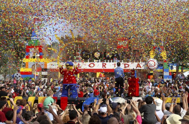 The confetti flies over the entrance to Legoland Florida as thousands pack the entrance for the grand opening ceremony, in Winter Haven on Oct. 15, 2011. (Joe Burbank/Orlando Sentinel file)