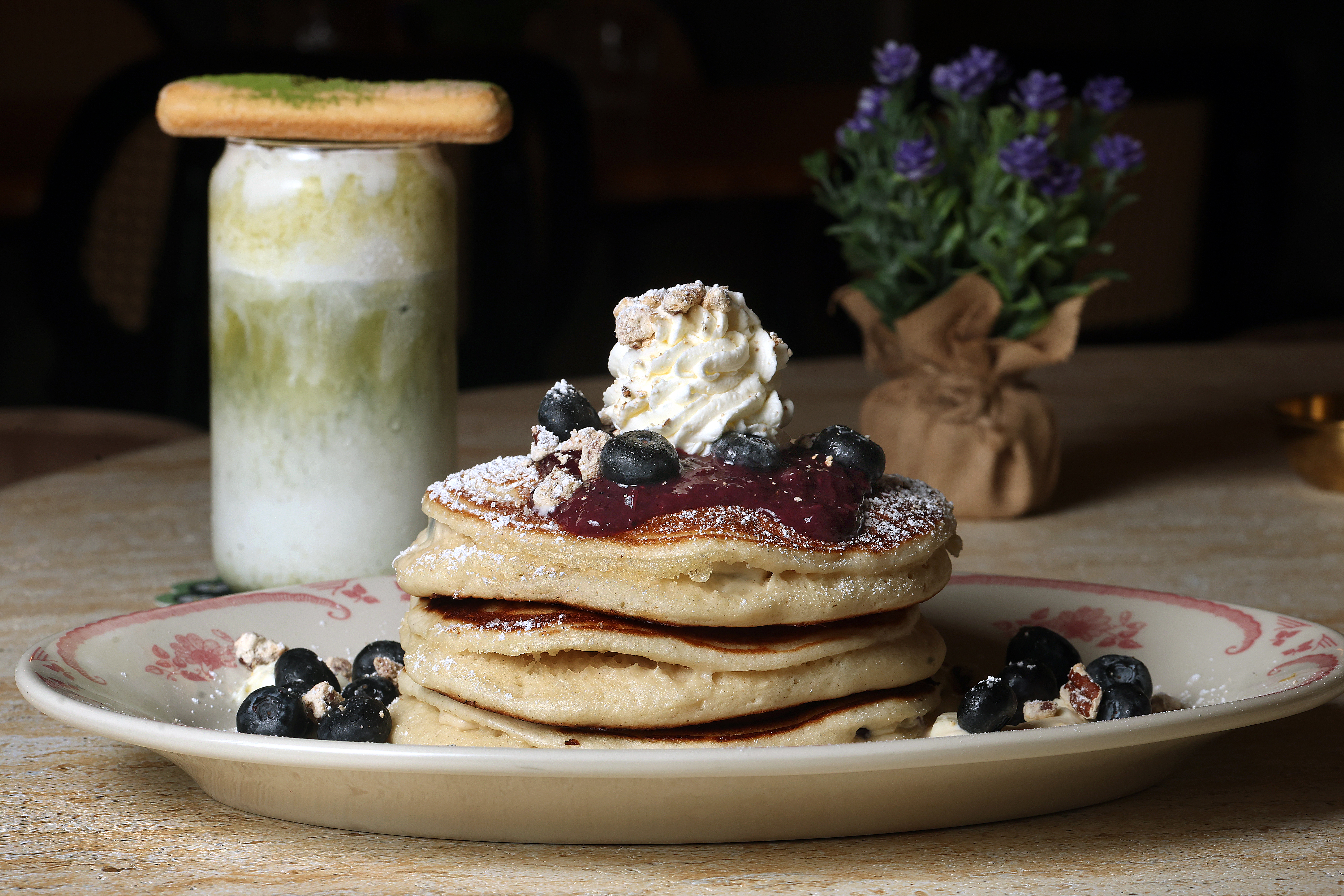 Blueberry Pancakes topped with berry compote, candied pecans and Grand...