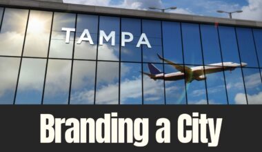 A plane reflected in glass at Tampa International Airport with the word Tampa displayed on the building exterior.