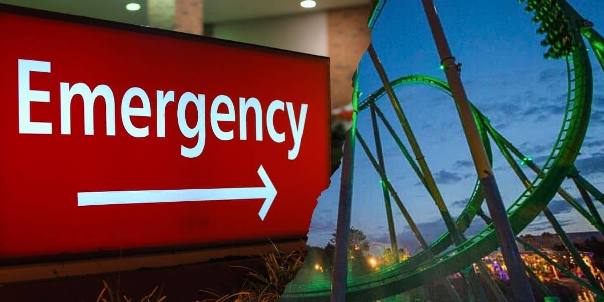 Emergency exit sign glows red beside The Incredible Hulk roller coaster inside of Islands of Adventure at Universal Orlando Resort as twilight falls over the park.